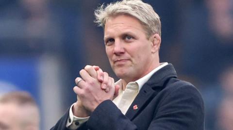 Lewis Moody clasps his hands