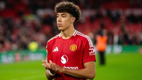 Ethan Wheatley of Manchester United applauds fans following the EFL Cup fourth round match between Manchester United and Leicester City at Old Trafford