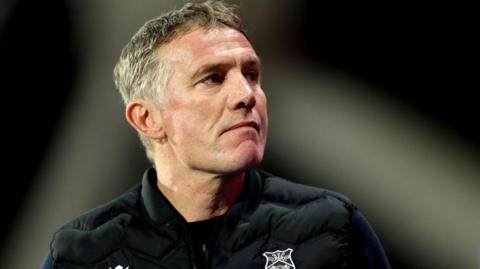Wrexham manager Phil Parkinson looks up from the technical area