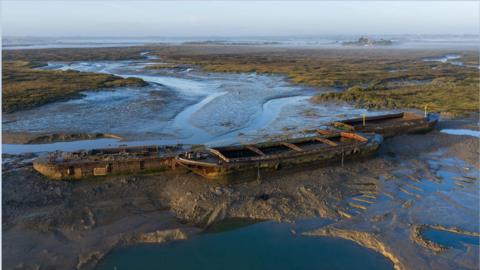 Three barges in the Blackwater Estuary in Essex.