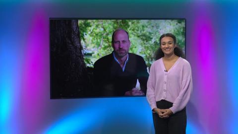 Nina in the Newsround studio with Prince William in the TV screen
