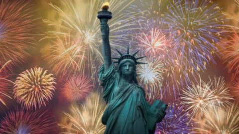 the Statue of Liberty with lots of fireworks going off behind it.