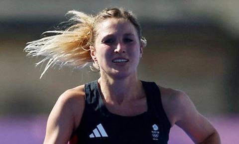  Rose Harvey in action before the finish line - close-up of her face grimacing and hair flying in the wind