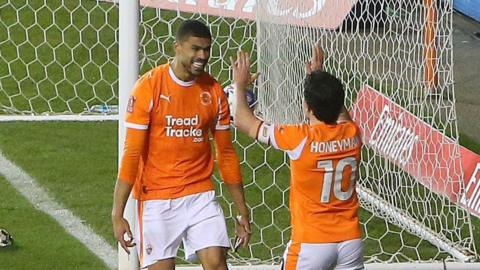 Ashley Fletcher celebrates scoring Blackpool's fourth goal against Carlisle