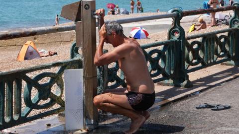 Man cooling down under tap