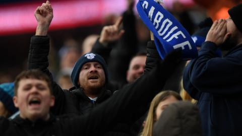 Cardiff City fans celebrate their team's goal against Stockport County