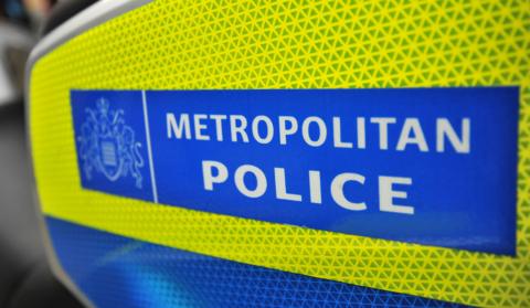 Close-up image of the Metropolitan Police logo, which has white lettering on a blue background and yellow border.