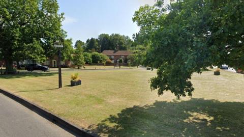 Sign reading Elstead on a village green 