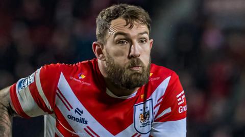 Daryl Clark in a red and white St Helens top with a straight face