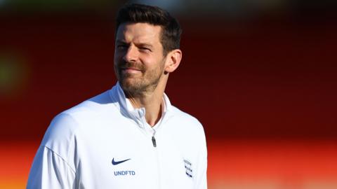 Lukas Jutkiewicz looks around as he walks on the pitch in his training top during the build up to a game