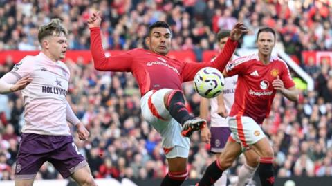 Manchester United midfielder Casemiro stretches for the ball