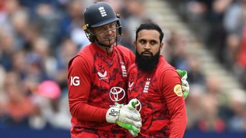 England captain Jos Buttler embraces spinner Adil Rashid after he takes a wicket