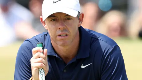 Rory McIlroy lining up a putt