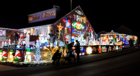 A house is covered in Christmas lights and decorations