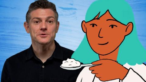 Man smiling as illustrated character presents him with a spoonful of yoghurt
