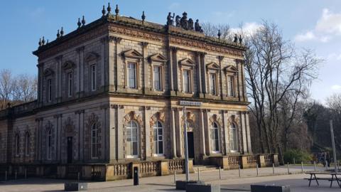 The Langside Halls building in Glasgow, a historic sandstone building, pictured on a sunny day.