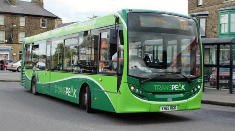 A green High Peak Buses bus. Its destination board says Derby.