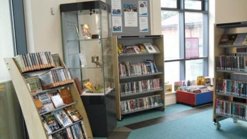 The inside of Springwood Library in Derby, with shelves and displays