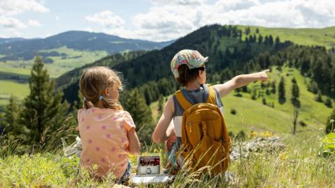 Two kids hiking a trail 