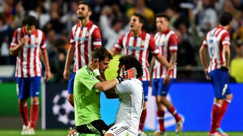 Real Madrid celebrate as Atletico Madrid look disappointed