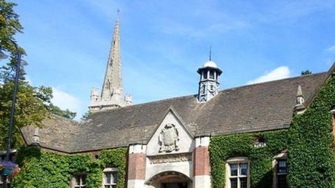 Grey slate roof of ivy-covered Victorian library building