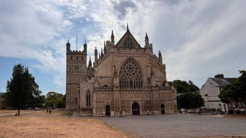 The outside of Exeter Cathedral. The cathedral green is parched after the current drought. 