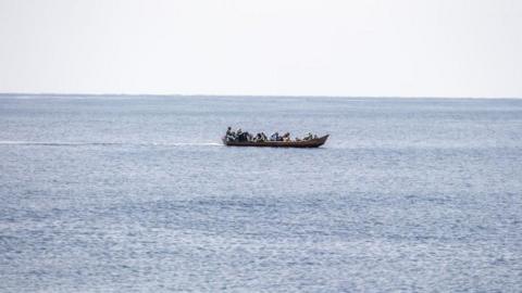 People on a boat as it moves through water