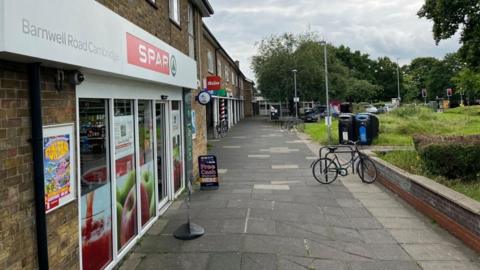 Cycle outside parade of shops