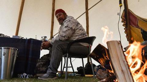 Pat King sits in a teepee during a sit-in protest at the Alberta Legislative Grounds