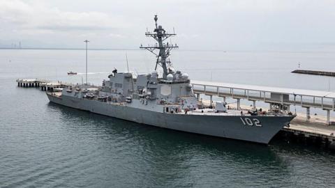 A wide shot of a US Navy warship USS Sampson