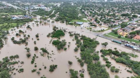 Drone view shows the flooded area at Molapo Crossing Mall and the Western Bypass Highway in Gaborone in Botswana on February 19 with tops of trees visible.