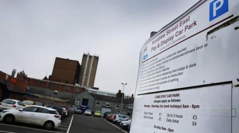 Kendrew Street East car park in Darlington. Several vehicles are parked in bays, while on the right-hand side of the photograph is a pay-and-display sign notifying drivers of the charges.
