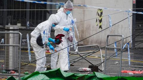 Forensic teams on Water Street