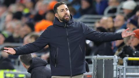 Stoke manager Narcis Pelach stretches out both arms by his side