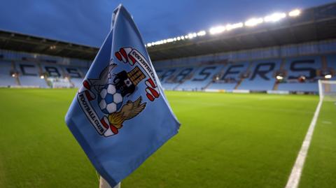 Coventry City's club badge on a corner flag at their home stadium