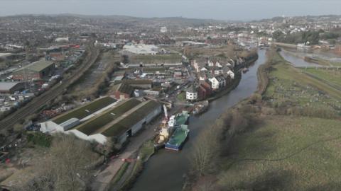 Aerial picture of the Water Lane development site showing the railway line to the left and Gabriel Wharf to the right alongside Exeter canal.