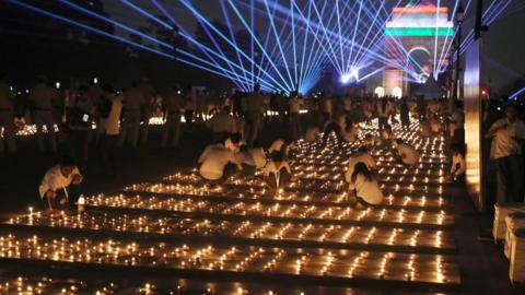 People light oil lamps in New Delhi, India, on the Kartavya Path