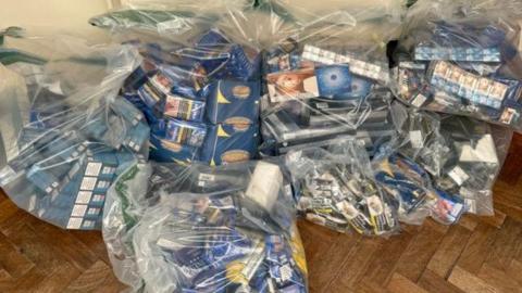 Seven large see-through plastic bags filled with illegal tobacco products which had been seized in the raids