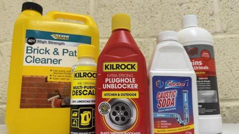 Five corrosive products lined up in a row including brick and path cleaner, multi-purpose descaler, extra strong plughole unblocker, caustic soda and cleaner for urinals.