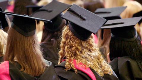 University students wearing graduation gowns