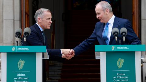 Taoiseach Micheal Martin TD (right) and Canadian Prime Minister Mark Carney shake hands during a press conference, following a a visit to Government Buildings in Dublin