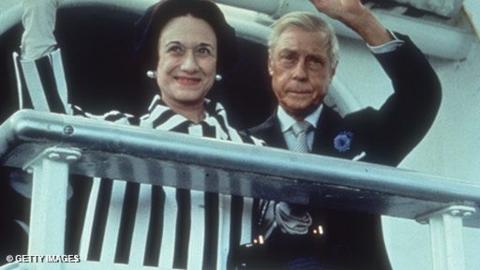 The Duke and Duchess of Windsor wave from a ship before disembarking.