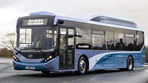 A single-decker bus in a car park.