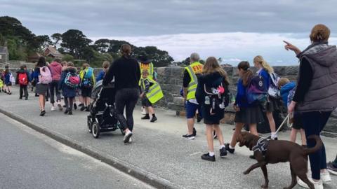 Children walking a long Perelle coast road