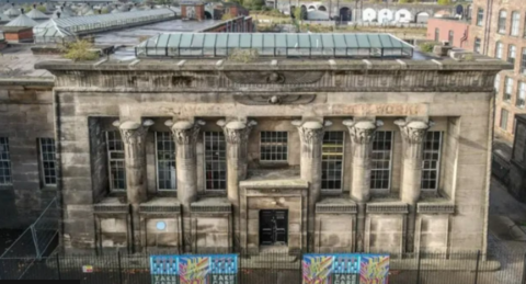 Temple Works mill in Leeds. A stone building with six pillars and glass roof.