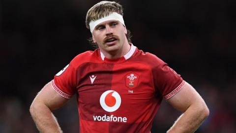 Aaron Wainwright for Wales with his hands on his hips