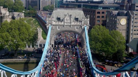 Aerial image of lots of London Marathon runners running along Tower Bridge.