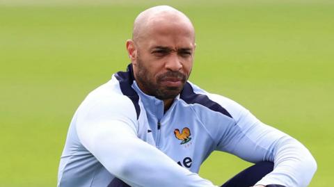 Thierry Henry sitting on a ball