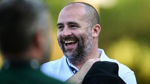 Paul Mitchell laughs
