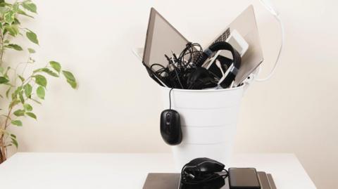 Electrical items like a mouse and headphones in the bin 